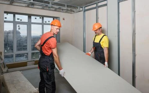 Drywall installation on the wall. Stock Photos