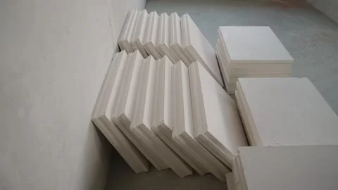 Drywall panels stacked against wall at construction site for interior finishing Stock Footage 334448910