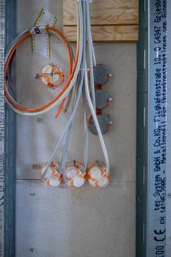 In a drywall run the power cables for the sockets Stock Photos