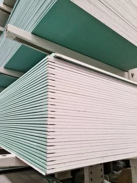 Drywall stacked in stacks at a hardware warehouse, vertical Stock Photos