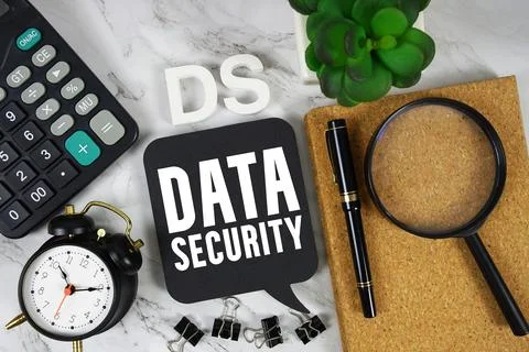 DS Data Security text with Calculator, alarm clock and magnifying glass on .. 写真素材