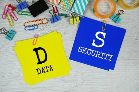 DS - Data Security text on stick note with stationery on concrete background Stock Photos