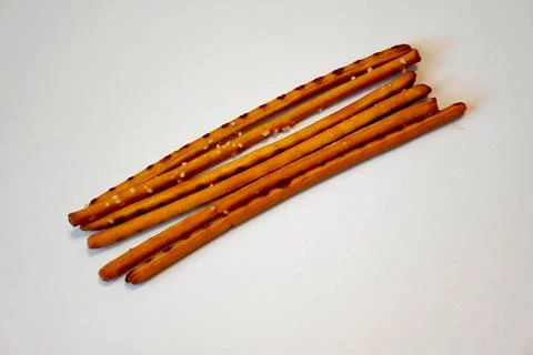 DSalted Breadsticks on White Background, Minimal Snack Food Concept with Copy Sp Stockfoto's