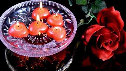 DSC 3798Red floating burning candles in glass bowls filled with water on black Stock Footage 149316320