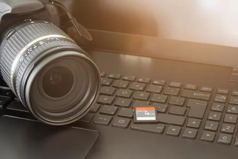 Dslr camera and memory card on computer Stock Photos