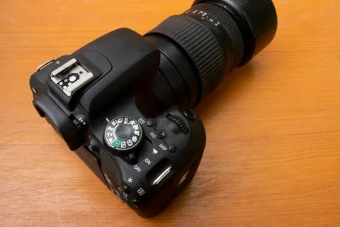 Dslr camera on brown background Stock Photos
