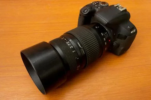 Dslr camera on brown background Stock Photos