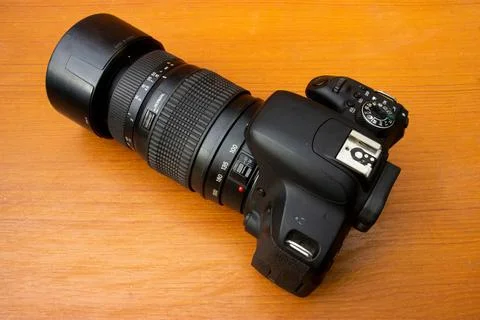 Dslr camera on brown background Stock Photos