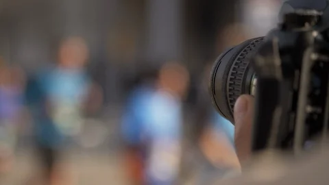 DSLR Camera Close Up taking pictures of an Urban Marathon. Slow Motion Video stock 104107077