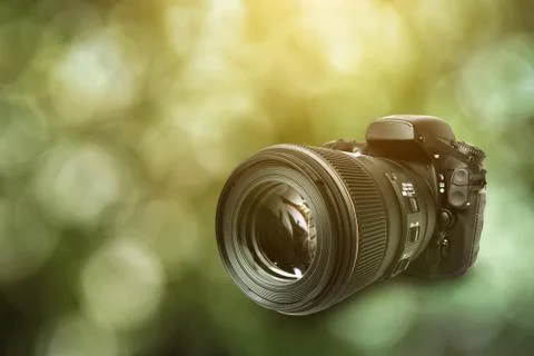 DSLR Camera on green background Stock Photos