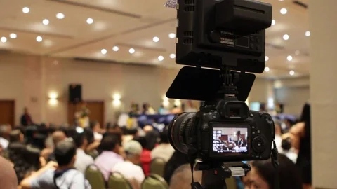 DSLR camera with LED light on top at graduation ceremony Stock Footage 122308497