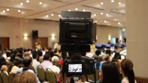 DSLR camera with LED light on top filming a graduation ceremony Stock-Footage 122308541