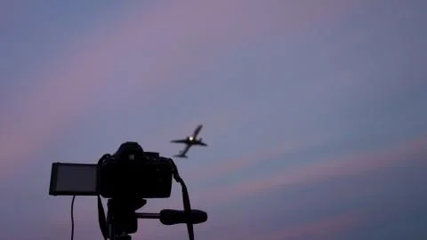 DSLR camera pointed at a jetliner taking off Stock Photos