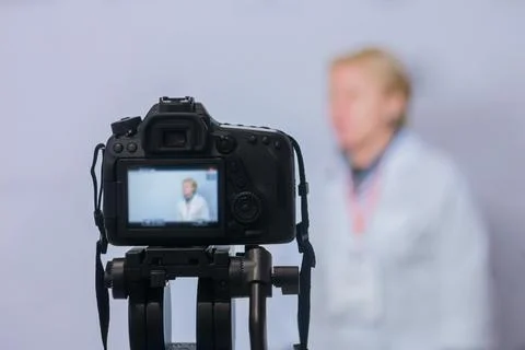 Dslr camera recording interview in broadcast news studio Fotos de archivo