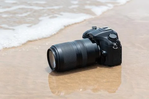 DSLR Camera on Sandy Beach Shore Stock Photos