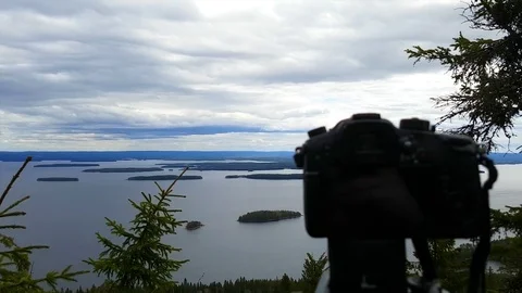 DSLR camera taking a time lapse photographs of a cloudy landscape, at a eveni Stock Footage 78495011