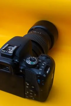 Dslr camera on yellow background Stock Photos