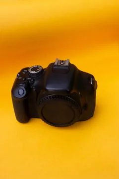 Dslr camera on yellow background Stock Photos