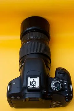 Dslr camera on yellow background Stock Photos