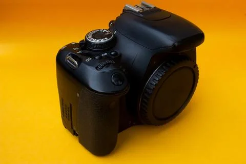 Dslr camera on yellow background Stock Photos