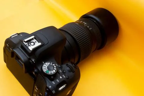 Dslr camera on yellow background Stock Photos