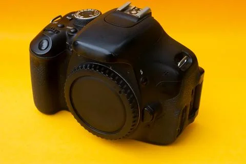 Dslr camera on yellow background Stock Photos