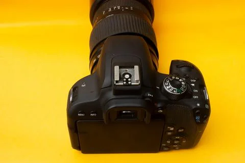 Dslr camera on yellow background Stock Photos
