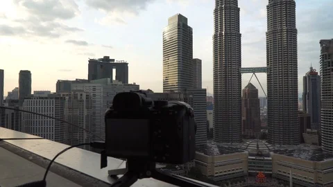 DSLR or mirrorless camera capturing or recording time lapse of Kuala Lumpur skyl Stock Footage 105327795