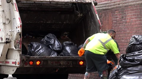 DSNY loading trash bags into garbage truck 4k Stock Footage 68207277