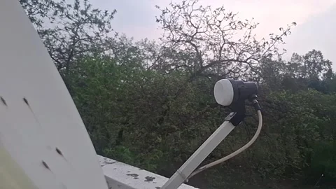 A DTH receiver and dish receive satellite signals, decoding digital TV Stock-Footage 306594235