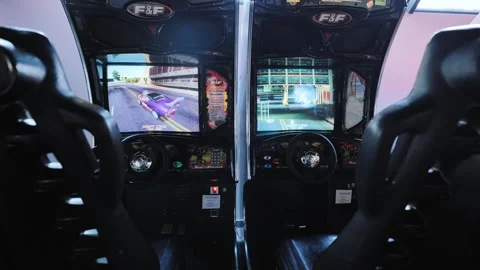 Dual Arcade Racing Simulators With Split Screens And Neon Game Lights Room Stock Footage 327721401
