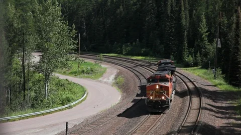 Dual freight engine approaches and passes under Stock-Footage 90500733