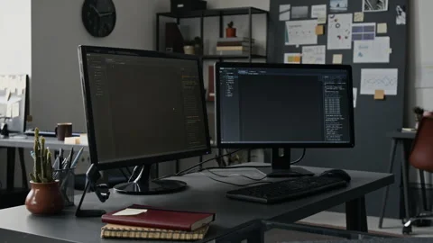 Dual Monitors Displaying Programming Code in Modern Office 動画素材 336711039