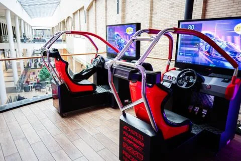 Dual racing simulator setup in a modern leisure mall environment with vibra.. Stock Photos