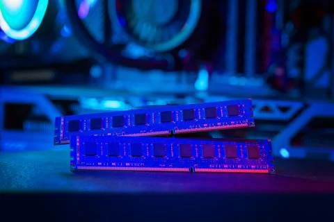Dual RAM memory modules with blue and purple lighting inside gaming compute.. Foto stock