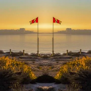 Dual reflective image of a flag for the currents at the beach in San Diego Stock Photos