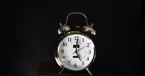 Dual silver bell alarm clock ringing loudly isolated on black 5:00 a.m. Stock Footage 206575372