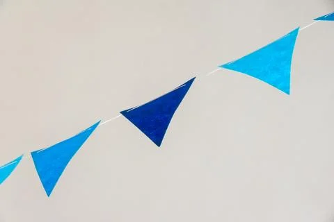 Dual-tone blue triangular bunting banner for gender-reveal or celebratory event Foto stock