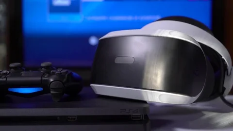 DualShock 4 controller and VR headset on Sony PlayStation 4 slim game console Stock Footage 76399116