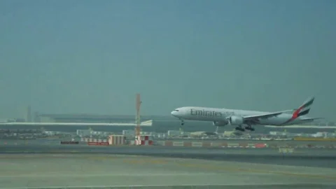 DUBAI, ARAB EMIRATES - 14.09.2016: Airplane flies over and lands in airport Stock Footage