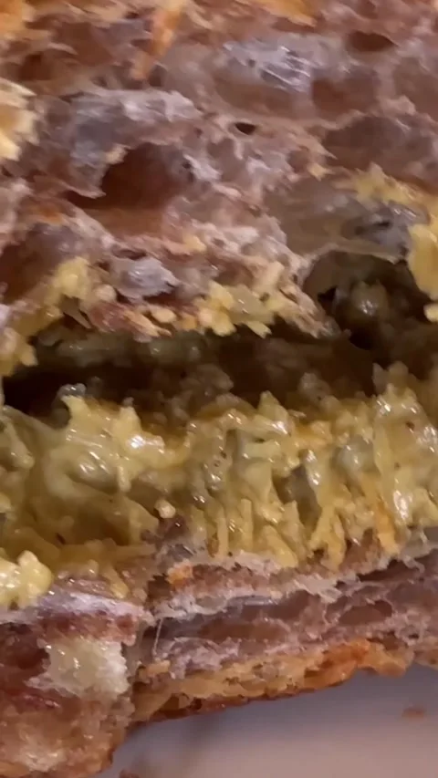 Dubai Chocolate Croissant stack of croissants with flakes of almond for sale in Stock Footage 306269237