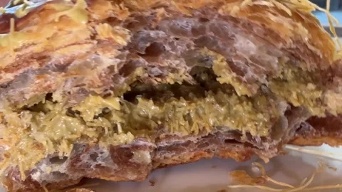 Dubai Chocolate Croissant stack of croissants with flakes of almond for sale in Stock Footage 306269255