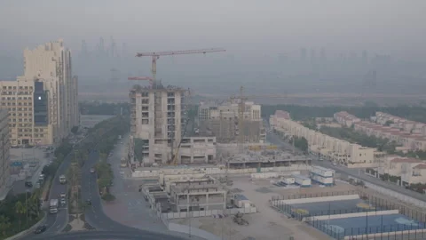Dubai cityscape, building under construction with crane, road with traffic Stock Footage 289656178