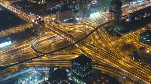 Dubai downtown intersection traffic night with city lights from above timelap Stock Photos