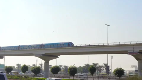 Dubai Elevated Metro Train Above Busy Highway with Cars Passing Below Stock Footage 321460881