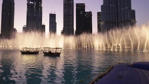 Dubai fountain with traditional abra boats in downtown Dubai Stock Footage