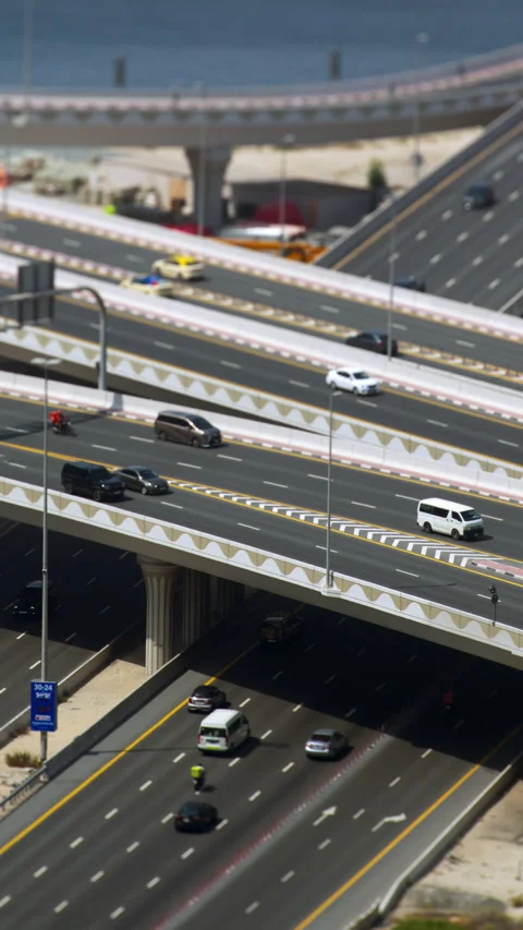 Dubai highway interchange with tilt shift effect, vertical view of traffic Video stock 340434535