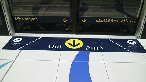 Dubai Metro Platform Edge with Bilingual Safety Signage and Floor Markers Stock Footage 335433207