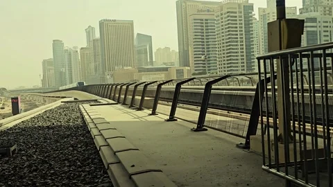 Dubai Metro train arrives at an elevated station 스톡 동영상 312003115