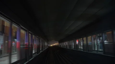 Dubai Metro train emerges past Emaar towers in Dubai UAE 库存影片 344912298